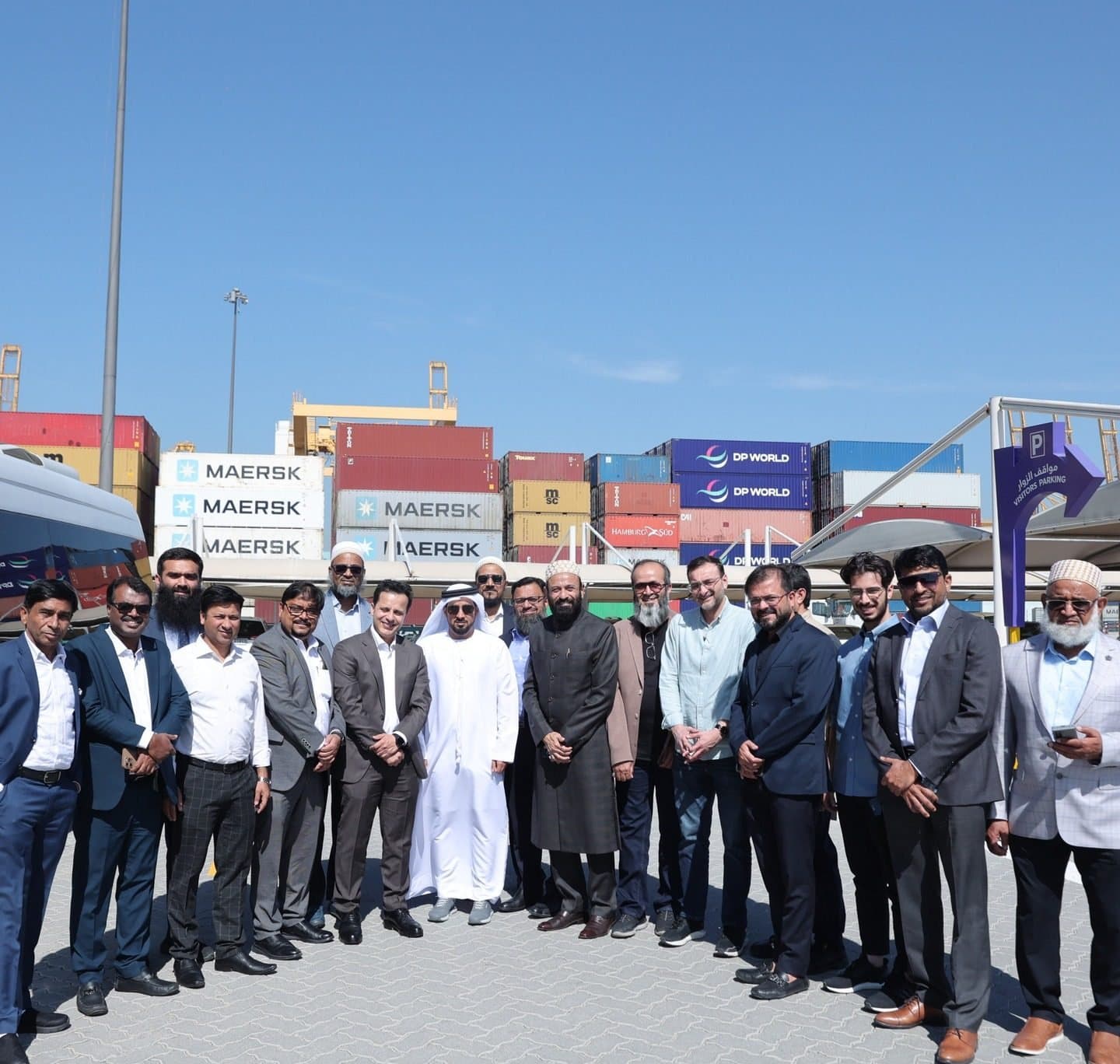 DP World, Boxbay Facility and Traders Market Visit: Group of members standing outdoors in front of stacked shipping containers