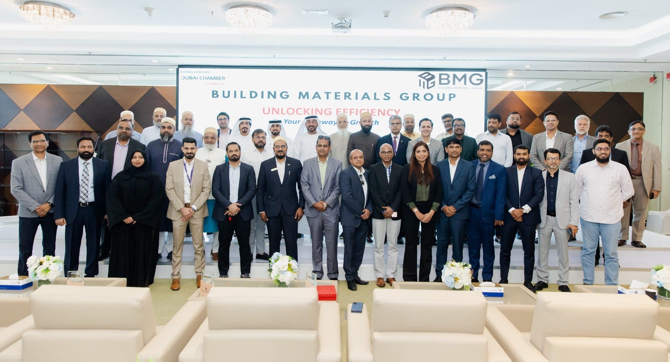Unlocking Efficiency: Your Gateway to Growth: Large group on a stage in front of a screen reading Building Materials Group