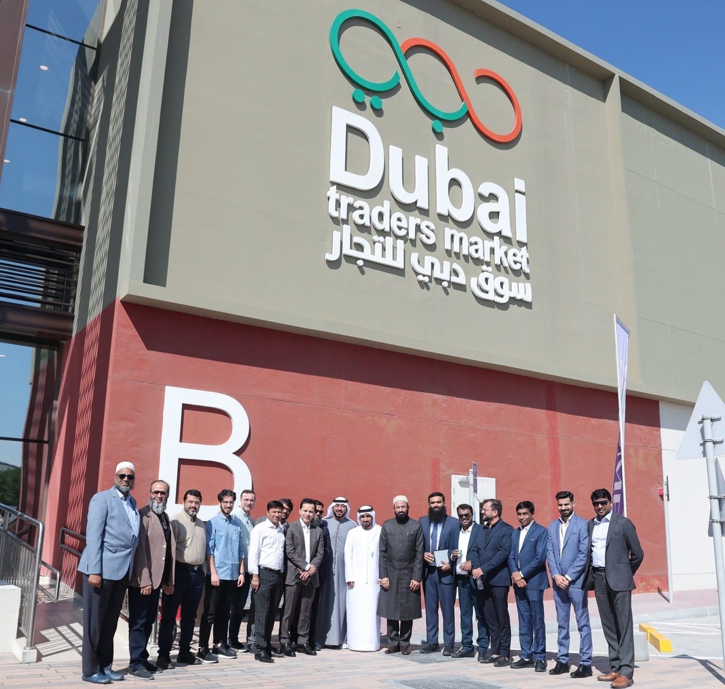 Members lined up outside the Dubai Traders Market building sign